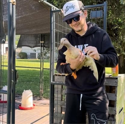 Kyle Kinkin holding a duck at Decent Ducks Sanctuary